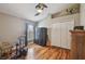 Bedroom features hardwood floors, a ceiling fan, and natural light from the large window at 10620 Tavistock Dr, Tampa, FL 33626