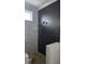 Modern bathroom features sleek black tiled shower, marble accent wall, and contemporary fixtures, for a luxurious feel at 1105 W Peninsular St, Tampa, FL 33603