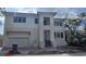 New construction home boasts a modern exterior, two-car garage, and meticulously landscaped front yard, adding curb appeal at 1105 W Peninsular St, Tampa, FL 33603