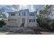 New construction two-story home featuring a modern design with stone accents, and an attached two-car garage at 1105 W Peninsular St, Tampa, FL 33603