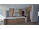 Spacious kitchen showcasing a large center island, custom cabinets, a stylish marble backsplash, and modern fixtures at 1105 W Peninsular St, Tampa, FL 33603