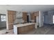 Modern kitchen featuring custom wood cabinets, marble backsplash, and a spacious center island with marble countertop at 1105 W Peninsular St, Tampa, FL 33603