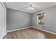 Bedroom with neutral colors, laminate flooring, ceiling fan, and a window with blinds at 1185 Sanger Ave, Spring Hill, FL 34608