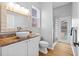 Bathroom featuring wood tile, granite counters, and a glass door to the backyard pool area at 11917 Middlebury Dr, Tampa, FL 33626