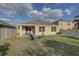 Backyard featuring an inviting seating area with lawn, creating a perfect spot for outdoor entertaining and relaxation at 12029 Gillingham Harbor Ln, Gibsonton, FL 33534