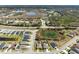 Overhead view of a residential area featuring modern homes adjacent to serene lakes and natural landscapes at 12698 Achasta Blvd, Hudson, FL 34669