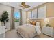 Comfortable bedroom showcasing a ceiling fan, cozy bedding, and a serene view from the window at 12785 Jade Empress Loop # 101, Venice, FL 34293