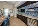 Entertainers wet bar with custom cabinetry, wine cooler and gorgeous countertop at 1325 Snell Isle Ne Blvd # 611, St Petersburg, FL 33704