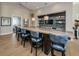Modern bar area with barstools, decorative shelving, a TV, and elegant lighting fixtures at 1325 Snell Isle Ne Blvd # 611, St Petersburg, FL 33704