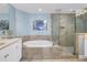 Well-lit bathroom featuring a soaking tub with tile surround and glass enclosed shower at 1325 Snell Isle Ne Blvd # 611, St Petersburg, FL 33704