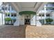 Welcoming building entrance with a covered entryway, lush trees, and warm lighting for an inviting arrival at 1325 Snell Isle Ne Blvd # 611, St Petersburg, FL 33704