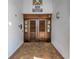 Elegant building entrance with wooden double doors, clear signage, and a brick walkway leading to the entrance at 1325 Snell Isle Ne Blvd # 611, St Petersburg, FL 33704