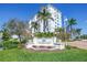 Exterior view of a white condominium building with lush landscaping and a decorative entrance sign at 1325 Snell Isle Ne Blvd # 611, St Petersburg, FL 33704