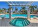 Inviting community hot tub surrounded by lush greenery, and a refreshing pool nearby at 1325 Snell Isle Ne Blvd # 611, St Petersburg, FL 33704