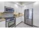 Stainless steel appliances, white cabinets, and a stylish backsplash highlight this modern kitchen at 1325 Snell Isle Ne Blvd # 611, St Petersburg, FL 33704