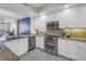 Beautiful kitchen featuring stainless steel appliances, white cabinetry, and backsplash at 1325 Snell Isle Ne Blvd # 611, St Petersburg, FL 33704