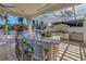 Outdoor kitchen features a granite counter bar, built-in grill, and pergola at 1325 Snell Isle Ne Blvd # 611, St Petersburg, FL 33704