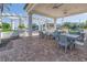 Inviting outdoor seating area with pergola, brick patio, ceiling fans, and lush greenery overlooking a canal at 1325 Snell Isle Ne Blvd # 611, St Petersburg, FL 33704