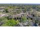 Aerial view of condo building with parking in the rear, and mature trees on the property at 13385 Arbor Pointe Cir # 203, Tampa, FL 33617