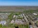 Panoramic aerial view of a community with a pool, surrounded by abundant trees and a clear blue sky at 13385 Arbor Pointe Cir # 203, Tampa, FL 33617
