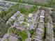 Aerial view of a condo community featuring a pool, tennis court, lush landscaping, and ample parking at 13385 Arbor Pointe Cir # 203, Tampa, FL 33617