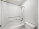 Clean, well-lit bathroom showcasing a bathtub with shower and standard toilet at 13385 Arbor Pointe Cir # 203, Tampa, FL 33617
