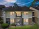 Inviting exterior of a multi-level condo with a balcony and a screened in porch overlooking a well-manicured lawn at 13385 Arbor Pointe Cir # 203, Tampa, FL 33617