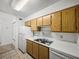 Well-lit kitchen boasts wooden cabinets, white countertops, and sleek appliances for modern convenience at 13385 Arbor Pointe Cir # 203, Tampa, FL 33617