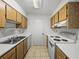 Functional kitchen with ample wooden cabinetry, white countertops, and modern appliances, perfect for cooking at 13385 Arbor Pointe Cir # 203, Tampa, FL 33617