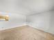 Bright, carpeted living room with white walls and a view to the kitchen at 13385 Arbor Pointe Cir # 203, Tampa, FL 33617