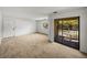 Bright living room with neutral carpet and a sliding door that leads to a balcony at 13385 Arbor Pointe Cir # 203, Tampa, FL 33617