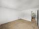 Bright and airy living room featuring neutral carpet and a view into an adjacent bathroom at 13385 Arbor Pointe Cir # 203, Tampa, FL 33617