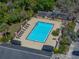 Aerial view showcasing a refreshing pool, lounge chairs, and a building with a relaxing atmosphere at 13385 Arbor Pointe Cir # 203, Tampa, FL 33617