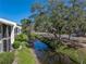 Picturesque view from property showcasing a peaceful canal and lush landscaping at 13385 Arbor Pointe Cir # 203, Tampa, FL 33617