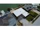 Aerial view of a home near the water, featuring a flat roof, a pergola, and nearby docks at 15306 Harbor Dr, Madeira Beach, FL 33708