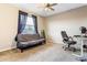 Bedroom with carpeted floors, a futon, a desk, and a window with natural light, perfect for a home office at 16313 Dinsdale Dr, Spring Hill, FL 34610