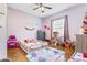 Charming bedroom with hardwood floors and a large window, creating a bright and inviting space at 16313 Dinsdale Dr, Spring Hill, FL 34610