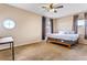 Neutral bedroom features carpet, a ceiling fan, and two windows at 16313 Dinsdale Dr, Spring Hill, FL 34610