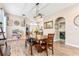 Open dining room with wood table, decorative lighting, and easy access to the front entry and laundry at 16313 Dinsdale Dr, Spring Hill, FL 34610