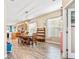 Open dining room with a wood table, wood-look floors, and access to the kitchen at 16313 Dinsdale Dr, Spring Hill, FL 34610