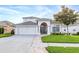 Beautiful two-story home boasts a well-kept lawn, charming accents and inviting two-car garage at 16313 Dinsdale Dr, Spring Hill, FL 34610