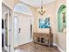 Inviting foyer with stylish chandelier, decorative wall niche, and a charming wood-look console table at 16313 Dinsdale Dr, Spring Hill, FL 34610