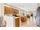 Spacious kitchen featuring an island, wood cabinetry, and an open layout to the dining area at 16313 Dinsdale Dr, Spring Hill, FL 34610