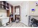 Laundry room with sink, shelves, washer and dryer, and a door at 16313 Dinsdale Dr, Spring Hill, FL 34610