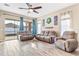 Inviting living room featuring tile floors, neutral paint, and sliding glass doors to the outdoors at 16313 Dinsdale Dr, Spring Hill, FL 34610