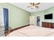 Bright main bedroom with wood-look floors, neutral walls, and an ensuite bath and walk-in closet at 16313 Dinsdale Dr, Spring Hill, FL 34610