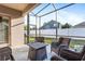 Screened patio area with chairs and a view of the backyard at 16313 Dinsdale Dr, Spring Hill, FL 34610