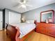 Bedroom with hardwood floors, ceiling fan, a large bed, and a wooden dresser at 17010 Aspen Meadows Dr, Lutz, FL 33548