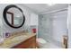 Bathroom featuring walk-in shower with glass door, granite vanity, and modern fixtures at 17940 Gulf Blvd # 2B, Redington Shores, FL 33708