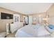 Bright bedroom with balcony access and ocean views, complemented by white furniture and soothing colors at 17940 Gulf Blvd # 2B, Redington Shores, FL 33708